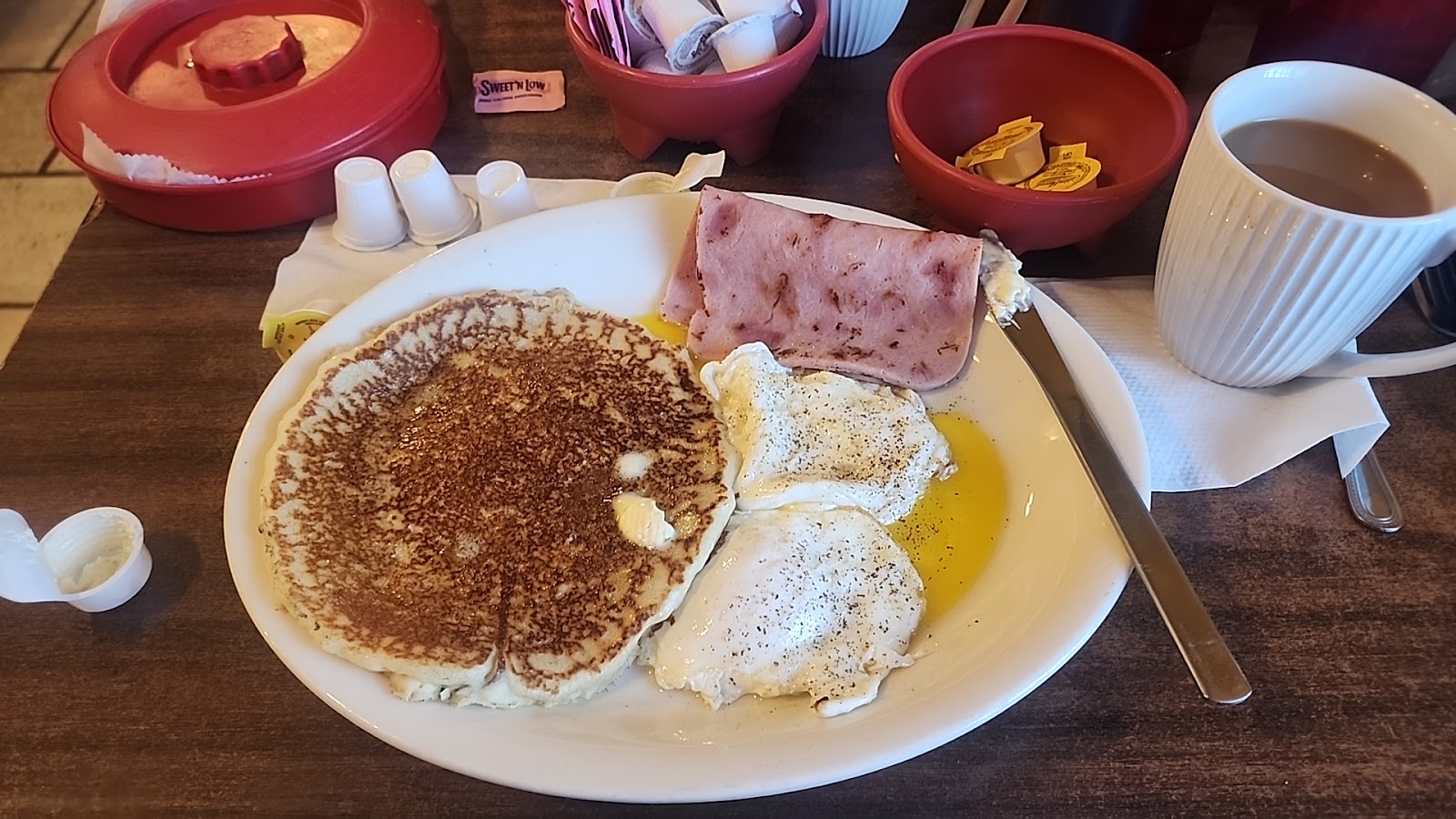 Buttermilk pancake plate with fried eggs and ham